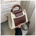 Dettaglio borsa Boston bicolore con manici rotondi e borchie dorate di classe - Bianco