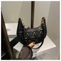 Detail of black crescent hobo bag with quilted texture and gold metal zipper hardware - Black