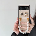 Samsung Galaxy Z Flip case in champagne gold with pearl wrist strap and rhinestone charms - Gold Fine Texture (Heart Bow Bear) / Samsung ZFlip3