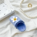 Light blue clogs phone grip with a cute yellow smiley daisy charm on white fabric - Light Blue