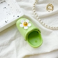 Mini green clog-shaped phone grip with a white smiley flower on soft white fabric - Light Green