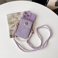 Close-up of purple leather iPhone case featuring a quilted mini pouch and gold flower charm - Eye-Design Camellia Wallet (Pearl Chain + Crossbody Strap) / Purple / iPhone 7/8/SE 2020