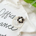 Detailed close-up of a pearl camellia phone grip with rhinestone floral accents - Pearl Rim Starry Drip Glue (Black) / Black Camellia