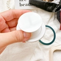 Close-up of white expandable magnetic phone grip stand held in hand for desktop support - Magnetic Stand - White