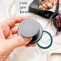 Detailed view of black matte collapsible phone socket holder with an accordion-fold design - Magnetic Grip - Black