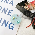 Detail of round phone socket holder with light blue base and colorful rhinestones - Basic Adhesive-Blue