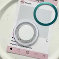 Detail of a turquoise metallic magnetic phone ring holder with its protective packaging - Magnetic Grip - Transparent Flat Round with Adhesive