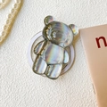 Detailed view of a holographic 3D bear phone grip holder on a white textured surface - Transparent Magnetic Stand-Silver Laser Bear-Grey