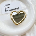 Detailed view of heart-shaped phone grip with gold bamboo texture frame and makeup mirror - Gold
