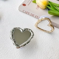 Detailed view of heart-shaped phone grips with metallic bamboo texture and mirror surface - Silver