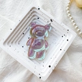 Macro detail of laser holographic bear phone grip on white decorative tray display - Bear Holder / Iridescent Transparent Gray