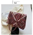 Detail der rot gewebten Tasche mit geometrischem Muster und Metallkettenriemen - Rot