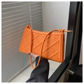 Detail of vibrant orange quilted shoulder bag with 3D diamond pattern and metal strap tips - Orange