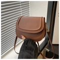 Detail of a brown PU leather saddle bag with vintage stitching and slim shoulder strap - Dark Brown