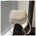 Detailed view of white saddle bag with premium PU texture and gold hardware details - White