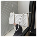 Detail of white quilted underarm bag featuring minimalist knot handle and PU leather texture - White
