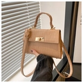 Close-up of light brown crocodile pattern crossbody bag with gold rectangular twist lock - Khaki