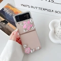 Detail of luxury transparent foldable phone case with pink flowers and rhinestones - Samsung ZFlip5 / Pink