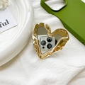Detail of a golden liquid metal heart phone grip with built-in makeup mirror on a case - Pleated Heart Mirror (700732) / Gold