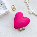 Detail of rose pink heart-shaped fabric phone grip with decorative woven label - Rose Red