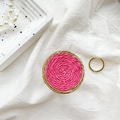 Macro detail of handwoven pink spiral texture on round collapsible phone socket grip - White Base-Handmade Color Block Woven-Rose Red