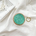 Detail of hand-woven color-block circular phone grip on textured white fabric - White Base-Handmade Color Block Woven-Light Green