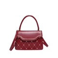 Dark red leather handbag with gold heart embroidery and scalloped trim on white background - Red