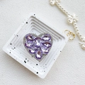 Macro view of luxurious purple rhinestone heart phone grip with sparkling crystals - Light Purple