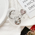 Detail view of heart-shaped resin phone grip with silver moon and tulip foil accents - Tulip Pink Heart No.5