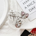 Detail of a heart-shaped resin phone grip with silver stars and pink rhinestone bow - Tulip Bow No.6