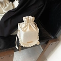 Creamy white bucket bag featuring a large pearl handle and a sleek gold chain strap - White