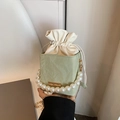 Mint green textured bucket bag featuring pearl handle and gold chain strap - Green