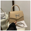 Detail of beige faux leather handbag featuring a silver metal bow accent and flap closure - Khaki