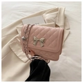 Detailansicht der rosa Stepptasche mit silberner Schleifenschnalle und eleganter Metallkette - Rosa
