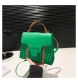 Detail of green faux leather handbag with crocodile pattern and brown decorative straps - Green