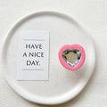 Detailed view of pink heart phone grip with faceted crystal gem on white ceramic plate - Transparent Stand - Rose Frame White Crystal