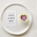Macro detail of heart-shaped purple faceted gem inside a pale yellow collapsible phone grip - Transparent Stand - Yellow Frame Purple Crystal