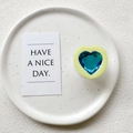 Detail of candy color 3D heart phone grip in blue and yellow on white ceramic plate - Transparent Stand - Yellow Frame Blue Crystal