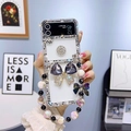 Detail of luxury Samsung Z Flip 6 clear case with purple crystal butterfly and beaded chain - Black / Samsung ZFlip3