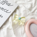 Close-up of lime yellow 3D flower phone grip with turquoise bead on fabric - Yellow Bowknot