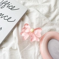 Close-up of a pink resin bow phone grip holder on a soft white linen background - Pink Bowknot