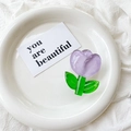 Close-up of a translucent purple tulip phone grip made of resin on a white plate - Crystal Tulip / Purple