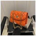 Close-up of bright orange quilted crossbody bag with gold chain strap and metal lock - Orange