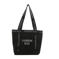 Black canvas tote bag with white FASHION BAG prints and spacious interior for daily commute - Black