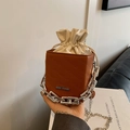 Brown leather bucket bag with cream drawstring and embossed letter texture with chain - Brown