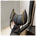 Detailed view of black quilted hobo bag featuring a chunky gold chain strap and smooth zipper - Black