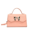 Pink crossbody bag with a golden bow detail and top handle on a white background - Pink