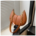 Macro detail of a brown crescent shoulder bag with golden chain and stitched leather - Brown