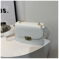 Close-up of matte white square crossbody bag showing gold buckle and wide strap details - White