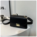 Detail of matte black leather bag featuring a gold metal buckle and wide strap - Black